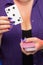 Female hands with a purple manicure hold a deck of play cards