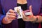 Female hands with a purple manicure hold a deck of play cards