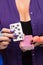 Female hands with a purple manicure hold a deck of play cards