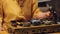 Female hands putting herbal leaves in teapot, performing history art traditions