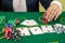 Female hands reaching for poker chips, play card in casino