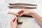 Female hands removing skin preparing eel fish