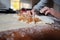 Female hands rolling homemade apple strudel