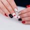 Female hands with romantic manicure nails, hearts design