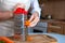 Female hands are rubbing fresh orange carrots on a steel silver grater. Grated carrots. Woman Chef prepares ingredients for