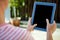 female hands scrolling on a tablet computer