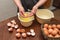 Female hands separate the protein from the yolk. Egg yolk in the palms. Making homemade biscuit