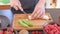 Female hands slicing banana.