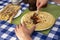 Female hands with spoon smearing jam or marmalade