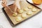 Female hands spread the cookie dough on a baking sheet covered with baking paper