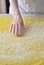 Female hands sprinkle flour on the dough