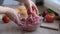 Female hands stirring ground beef on the kitchen table with burger ingredients, cooking at home.