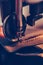 Female hands stitching a part of the shoe  in the handmade footwear industry