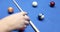 Female hands take two balls of billiard table