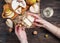 Female hands takes peace of cheese and pear from table with food