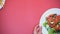 Female hands taking white plates from pink background, tasty dinner restaurant