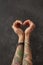 Female hands with tattoos in shape of heart