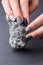 Female hands with textured silver mineral