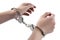 Female hands in tight fist on handcuff on white isolated background