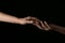 Female hands touching fingers on dark background