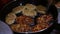 Female Hands Turning Meat Cutlets in a Frying Pan.