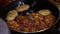 Female Hands Turning Meat Cutlets in a Frying Pan.