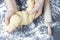 Female hands twisting dough, concept in home baking, grey background