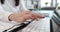 Female hands typing on keyboard on laptop closeup