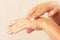 Female hands using anti-aging skin cream