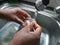 Female hands washing sea bream