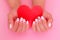 Female hands with white manicure nails, hearts design