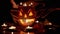 Female Hands of Witch Conjures Over Burning Head of Jack Lantern Pumpkin. 4K