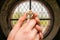 Female hands with wooden cross and window inside the church