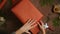 Female hands wrapping Christmas present with kraft paper.