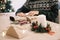 Female hands wrapping present on wooden table