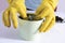 Female hands in yellow gloves transplant a violet houseplant. high quality