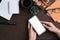 Female Hans holding smart phone with blank screen on brown office desk.