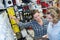 Female hardware store worker helps to choose