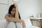 Female having depression sitting alone in bedroom corner. woman headache unhappy emotion. young anxiety despairing mental health