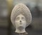 Female head from terracotta figurine with triangular complicated headdress