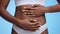 Female health and fertility concept. Close up shot of young unrecognizable african american woman touching her belly