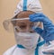 Female health worker takes off protective glasses exhausted from fatigue after battling the terrible Coronavirus Covid-19 in Italy