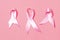 Female Healthcare Ideas. Flat-lay Image of Three Pink Ribbons Against Coral Background as Symbol of Breast  Cancer Awareness