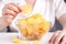 Female with heap of potato chips in big dish