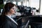 Female helpdesk operator stands with a folder in her hands. An office manager with a headset answers customer calls