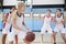 Female High School Basketball Team Dribbling Ball On Court