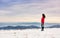 Female hiker admiring winter scenery on a mountaintop