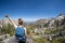 Female hiker with backpack along the Sawtooth Lake trail in Idaho. Back facing camera. Concept for solo female travel and hiking