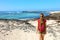 Female hiker backpacker enjoying view of amazing wild beach in Fuerteventura, Canary Islands