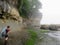 A female hiker carefully navigating the coast line along the West Coast Trail